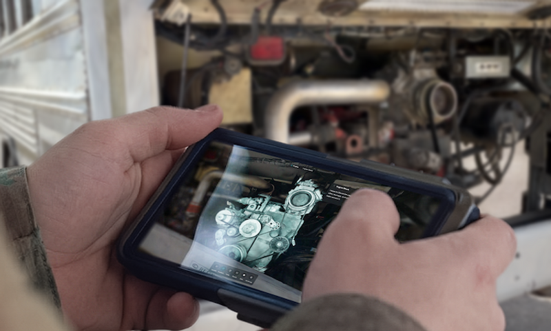 Maintainer looking at 3D model on tablet