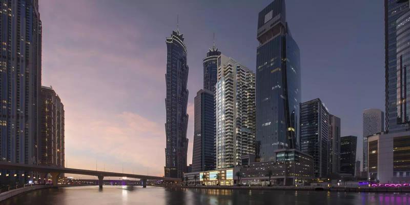 Urban Oasis by Missoni residential facade with canal and skyline backdrop, Business Bay