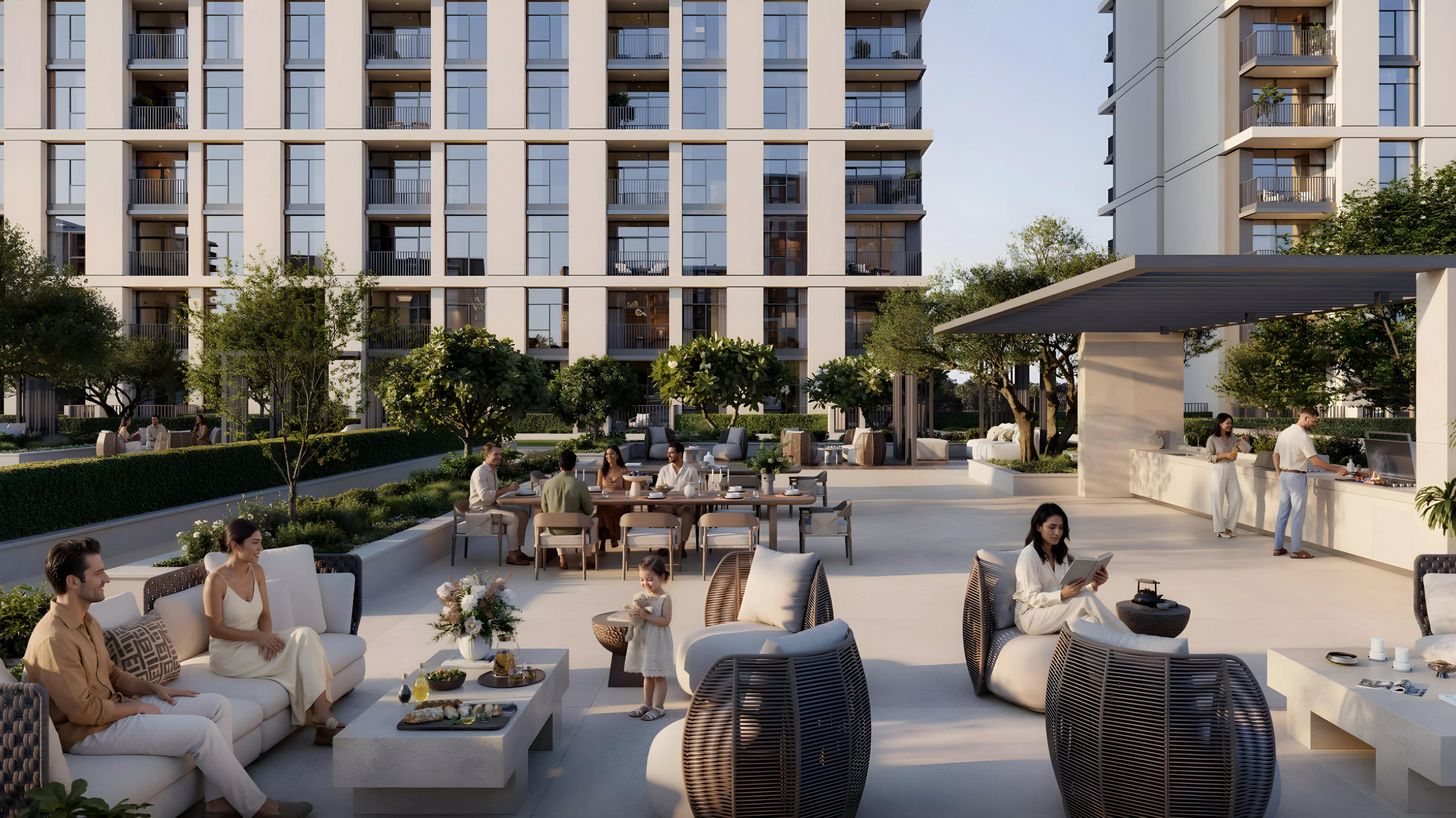 Terra Woods residents lounging on shaded podium terrace with dining tables and lounge seating