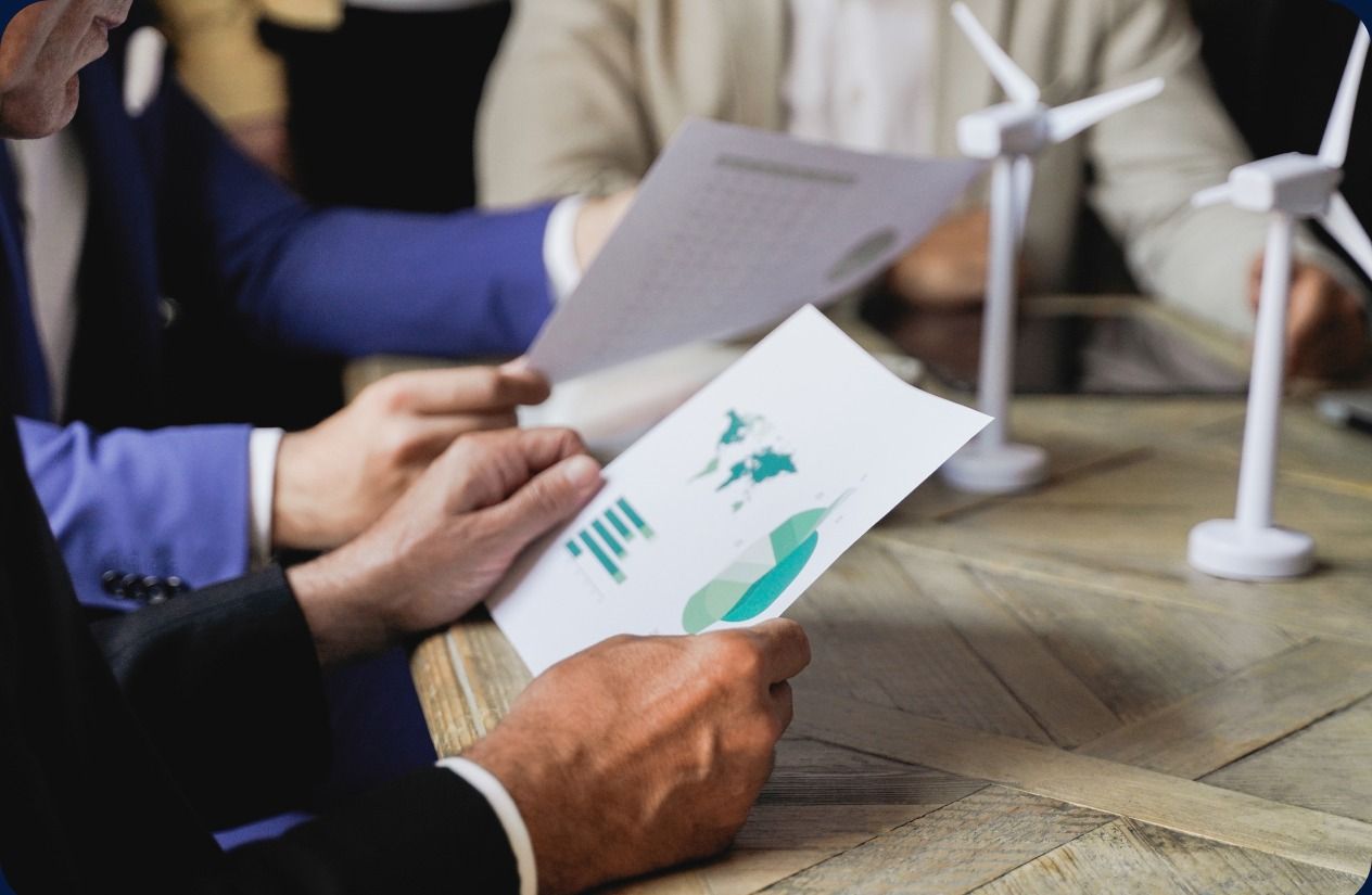 Investors going over a chart at a meeting table