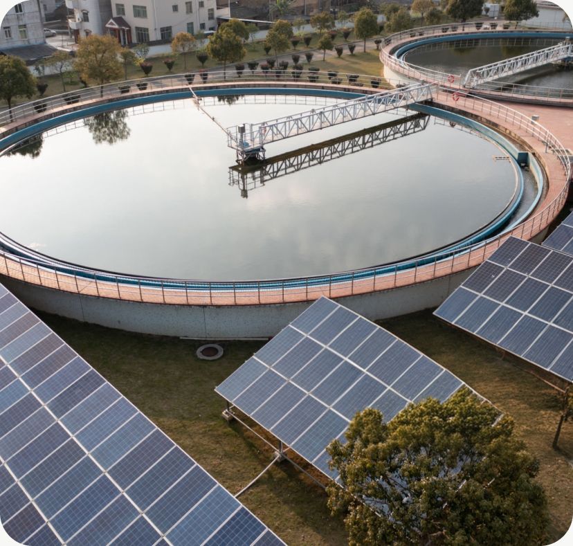 Aerial view of a clarifier tank with solar panels alongside it