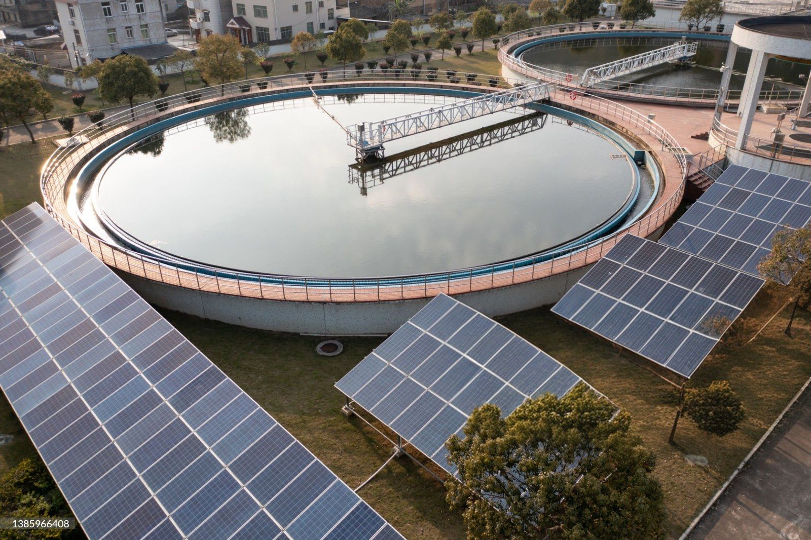 Solar panels beside the tanks of a water treatment plant
