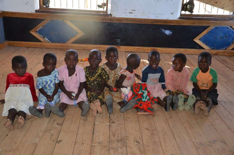 Children sitting on wooden (not concrete or earth) floor at M'teza CBCC