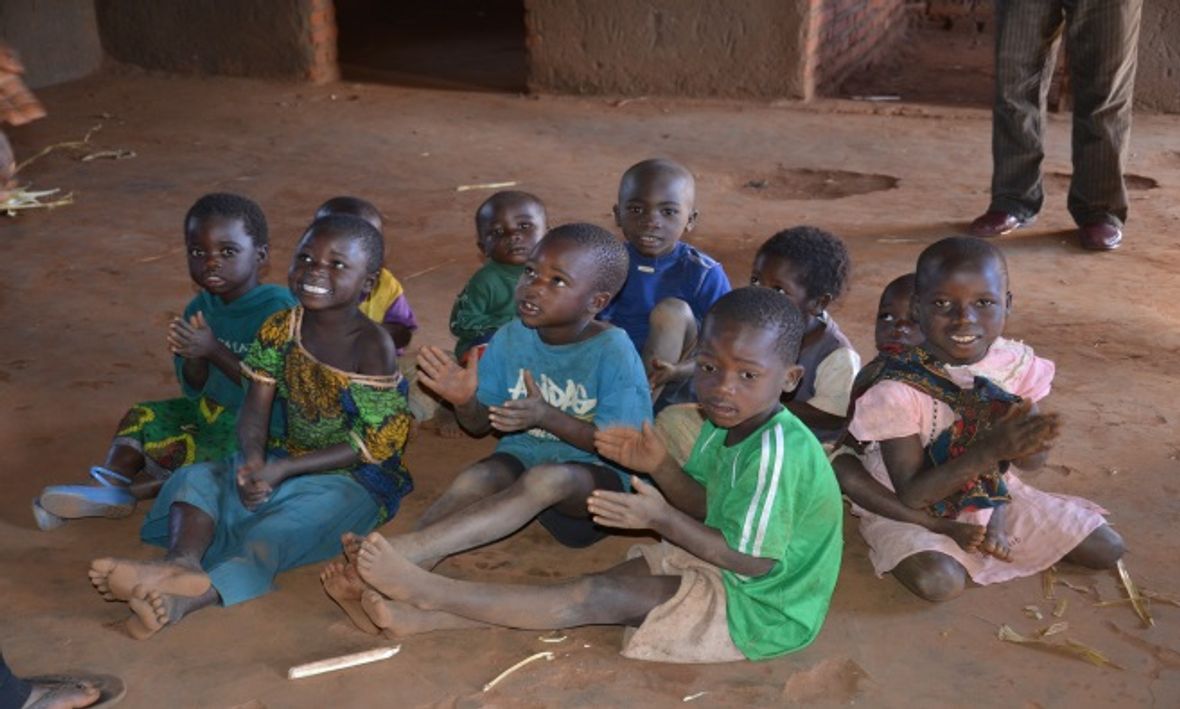 Children singing and clapping to a song at Chiweza II CBCC
