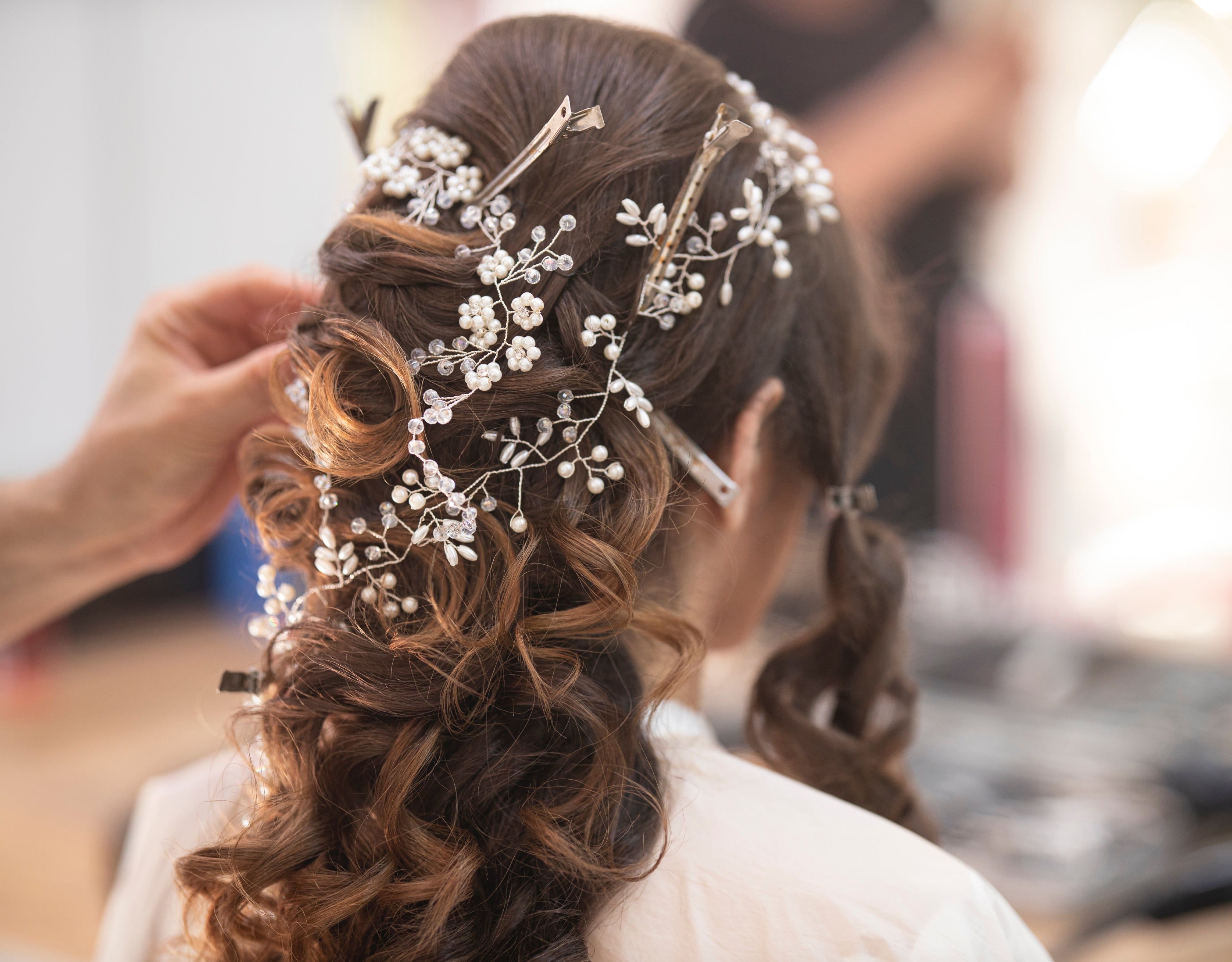 Bride having her hair done before the wedding