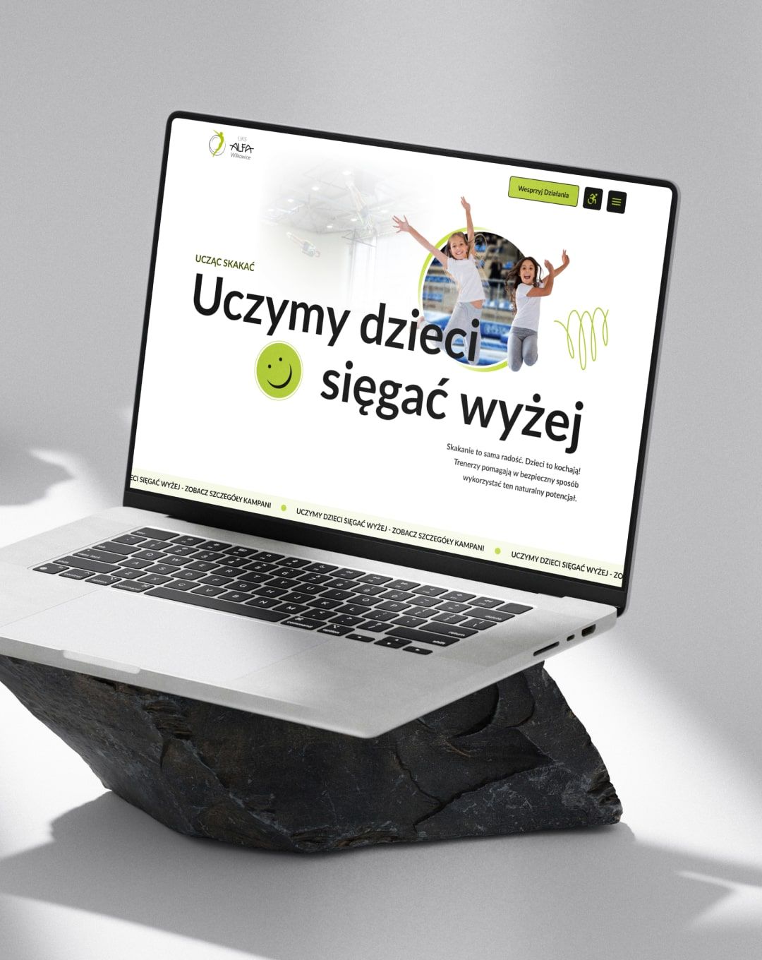 Home Page Banner Mockup on laptop view - By teaching trampoline jumping - we teach children to achieve more