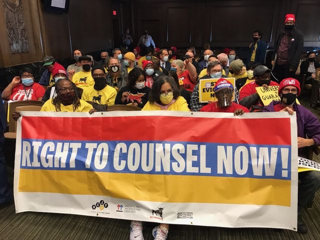 Workers and tenants holding a Right to Counsel Now banner in 2021