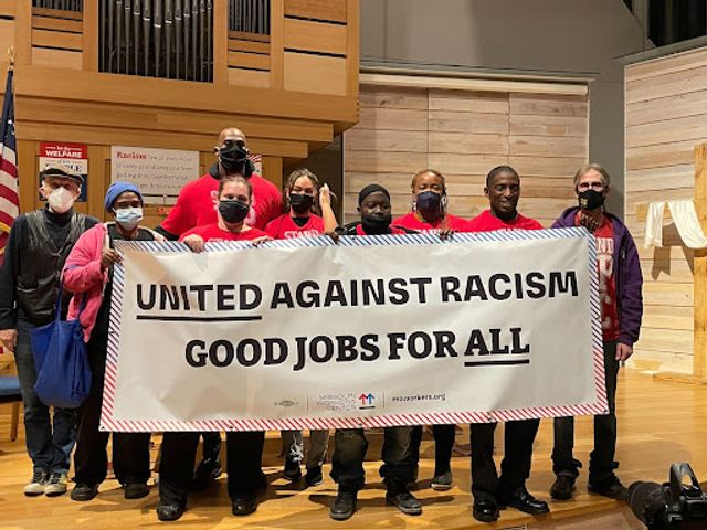 Missouri Workers Center members holding a United Against Racism, Good Jobs for All banner