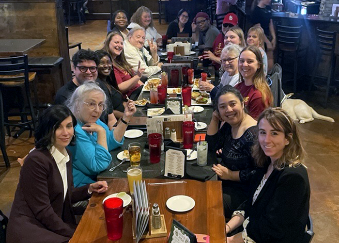 Heartland staff and supporters gather around a restaurant table