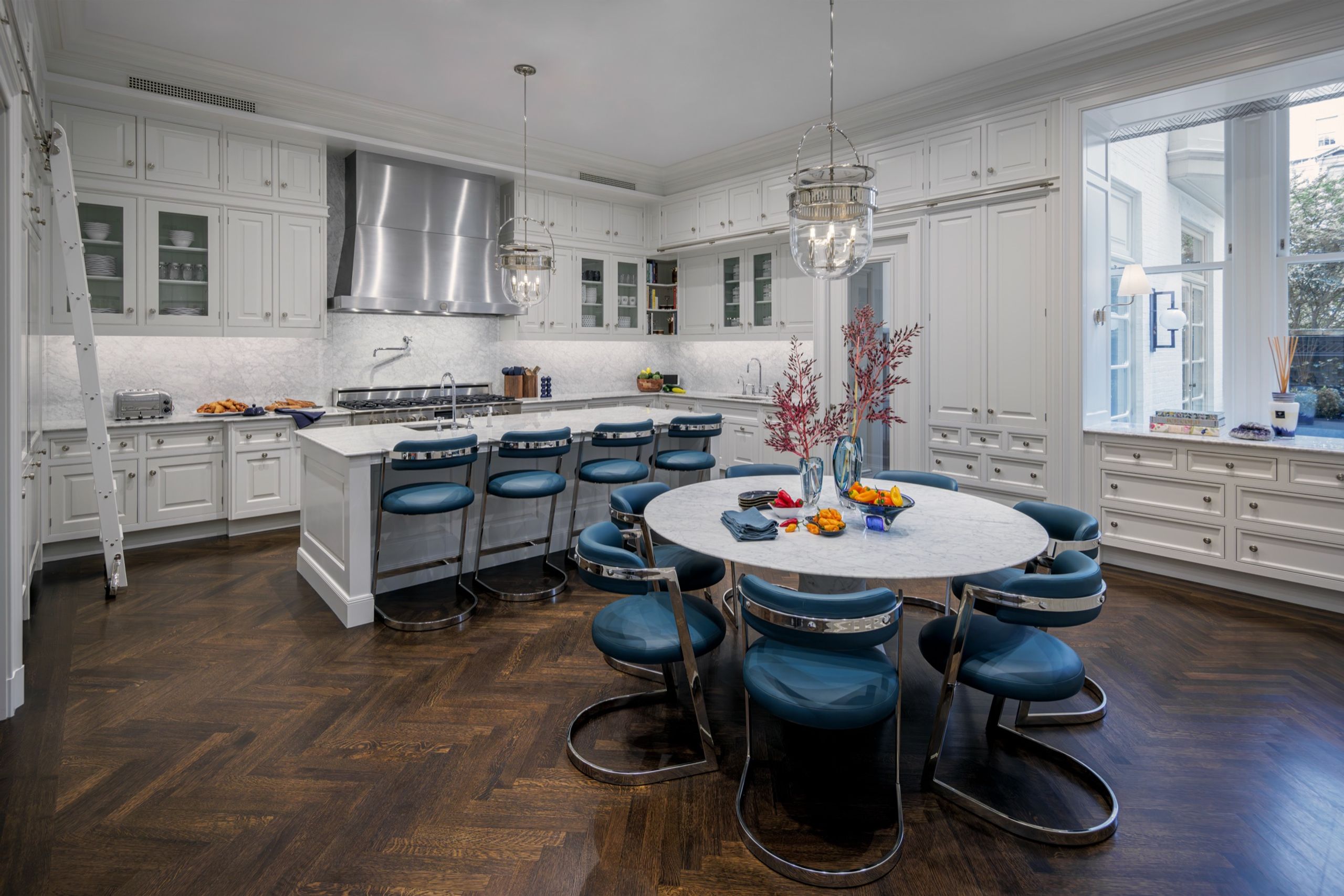 Kitchen with a marble dining table and blue leather chairs