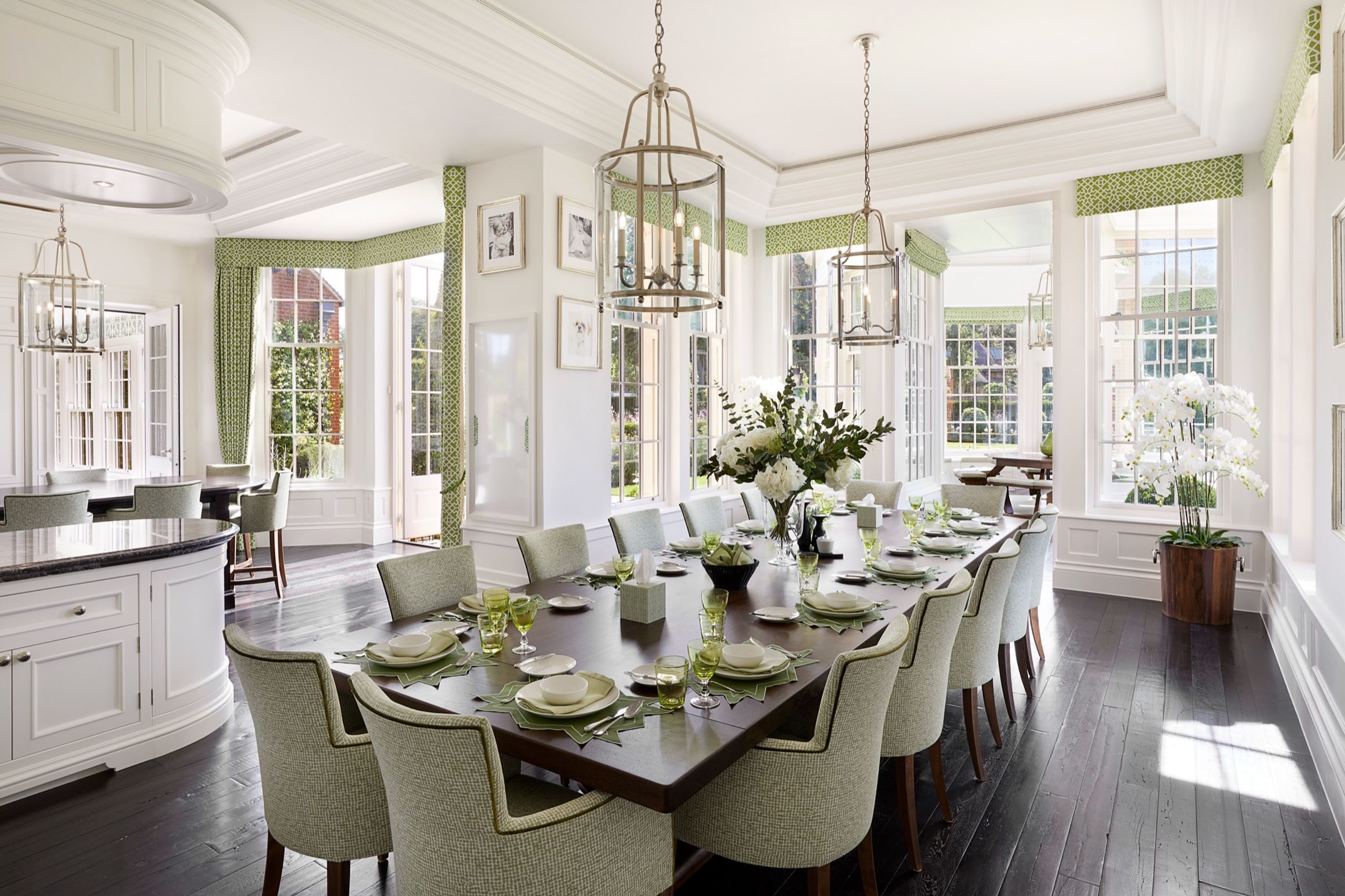 Dining room with lantern pendants and a long table set for dinner