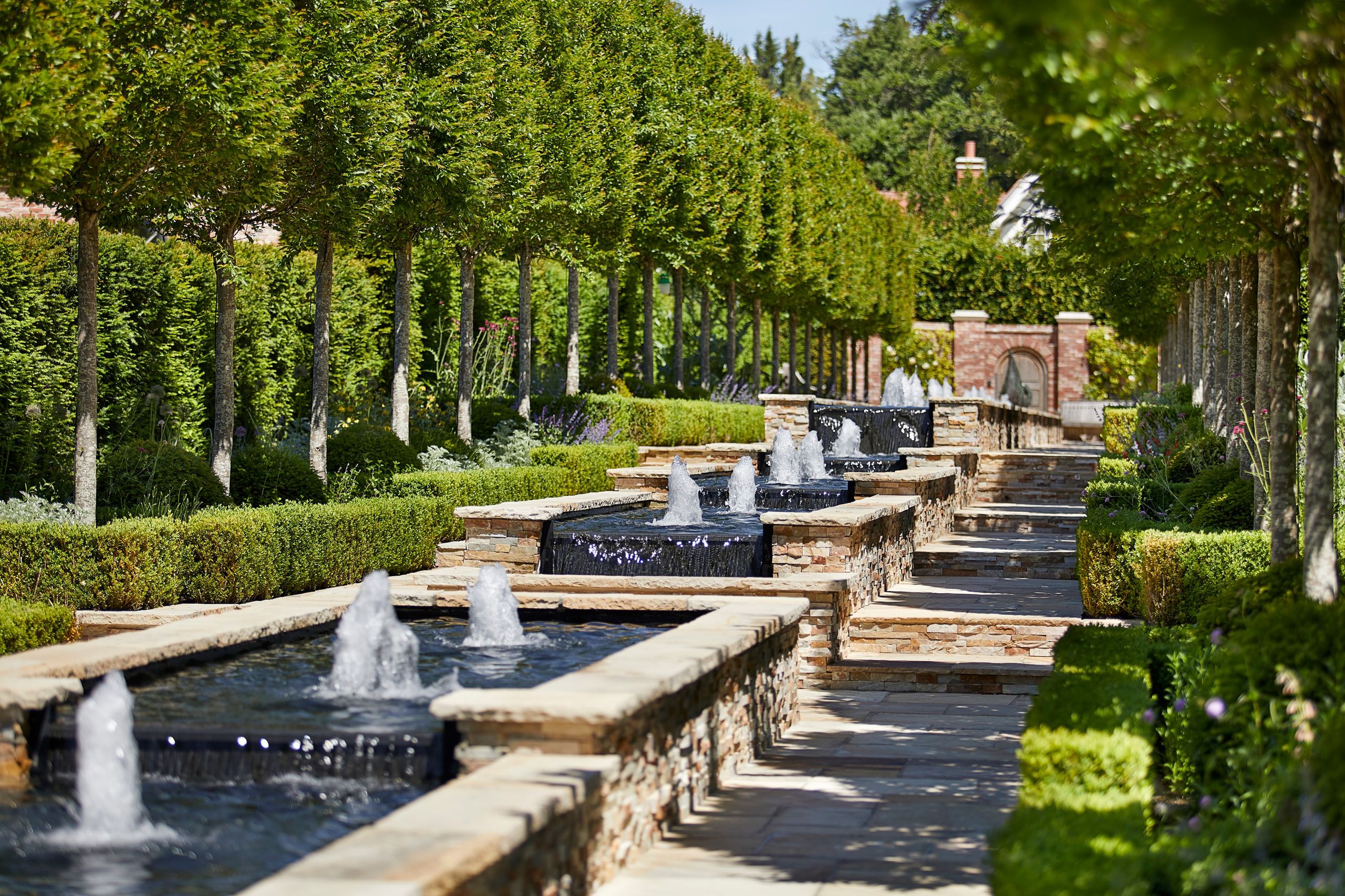 Client portfolio photograph: tree-lined fountains in the Cheval gardens
