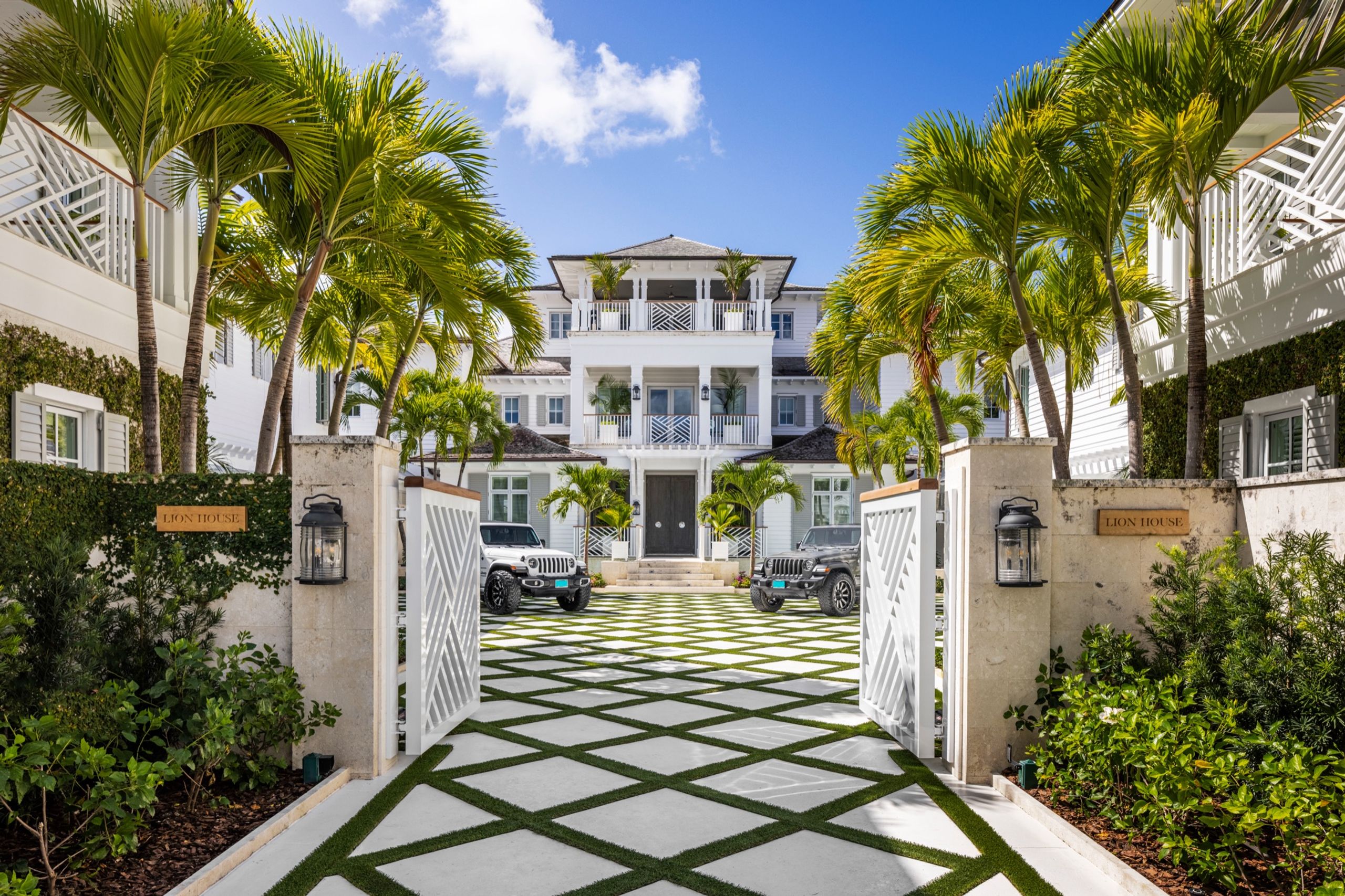Entrance courtyard of a residence, lined with palms