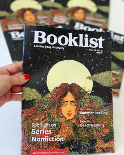 A hand holding the 4/1/2020 edition of Booklist, which features Lobizona as the cover image.