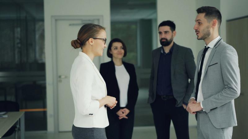 humans talking to each other. team gathering to welcome new team member
