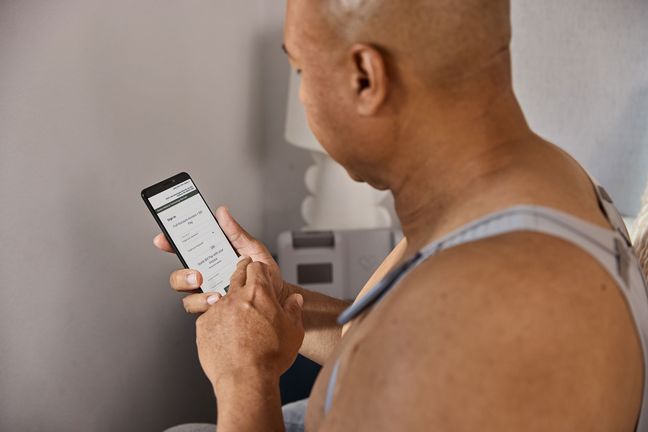 individual wearing SensorFit garments and interacting with phone showing a payment portal