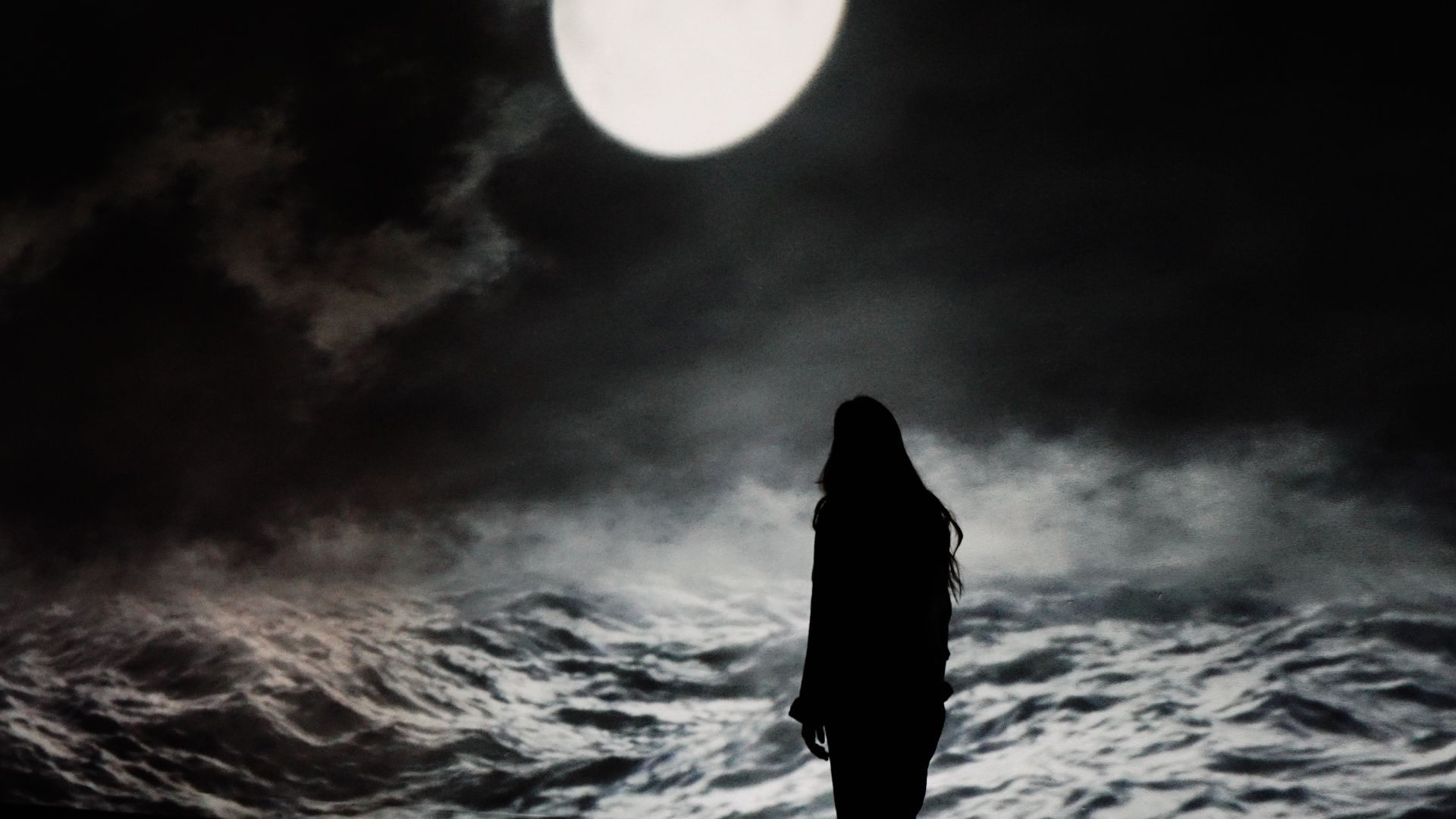 Women stood in front of huge 3D animated ocean scene projected on wrap around immersive screens