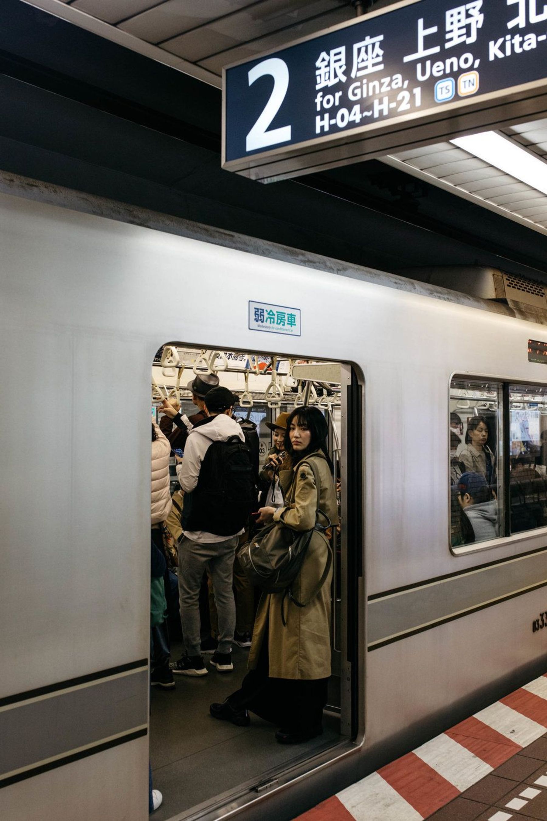Passengers boarding a train at a Tokyo underground station.