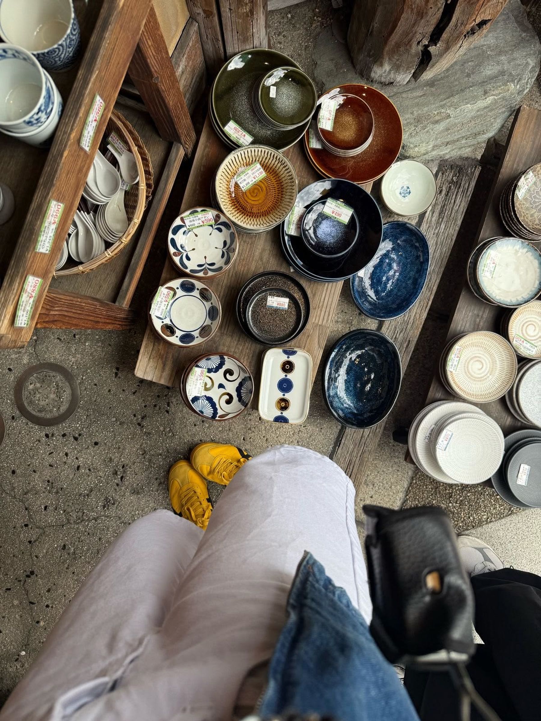 Colourful ceramic bowls and plates displayed in a Japanese shop.