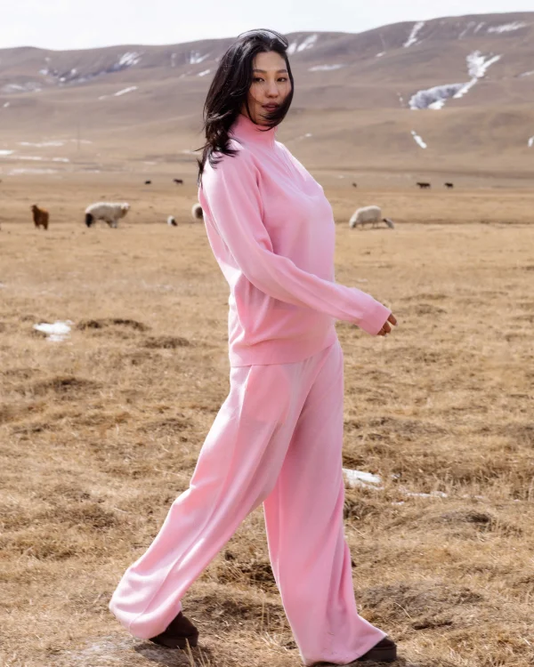 woman in a Mongolian field in a cashmere jumpsuit