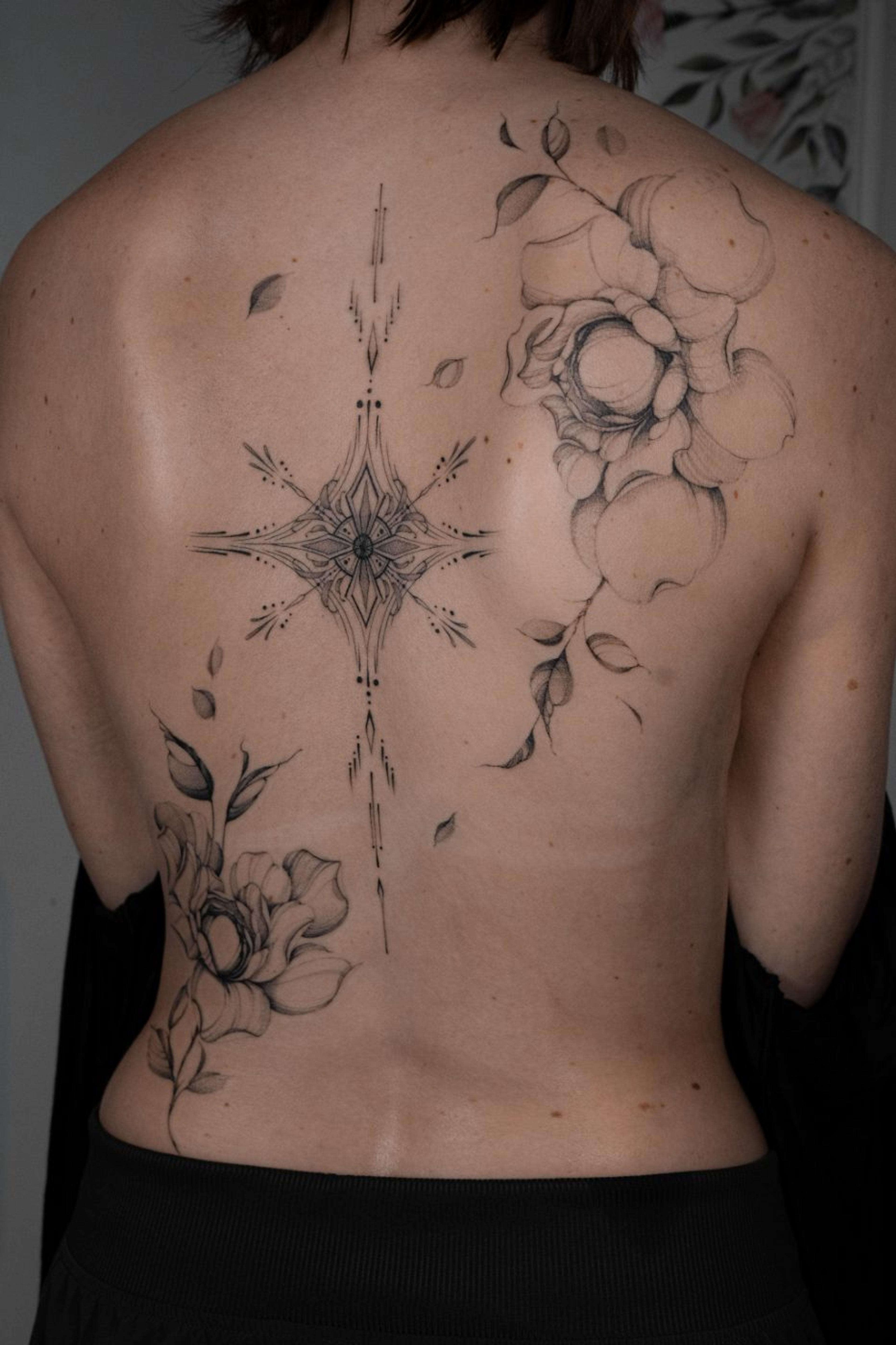 Fine-line ornamental spine piece between two floral studies