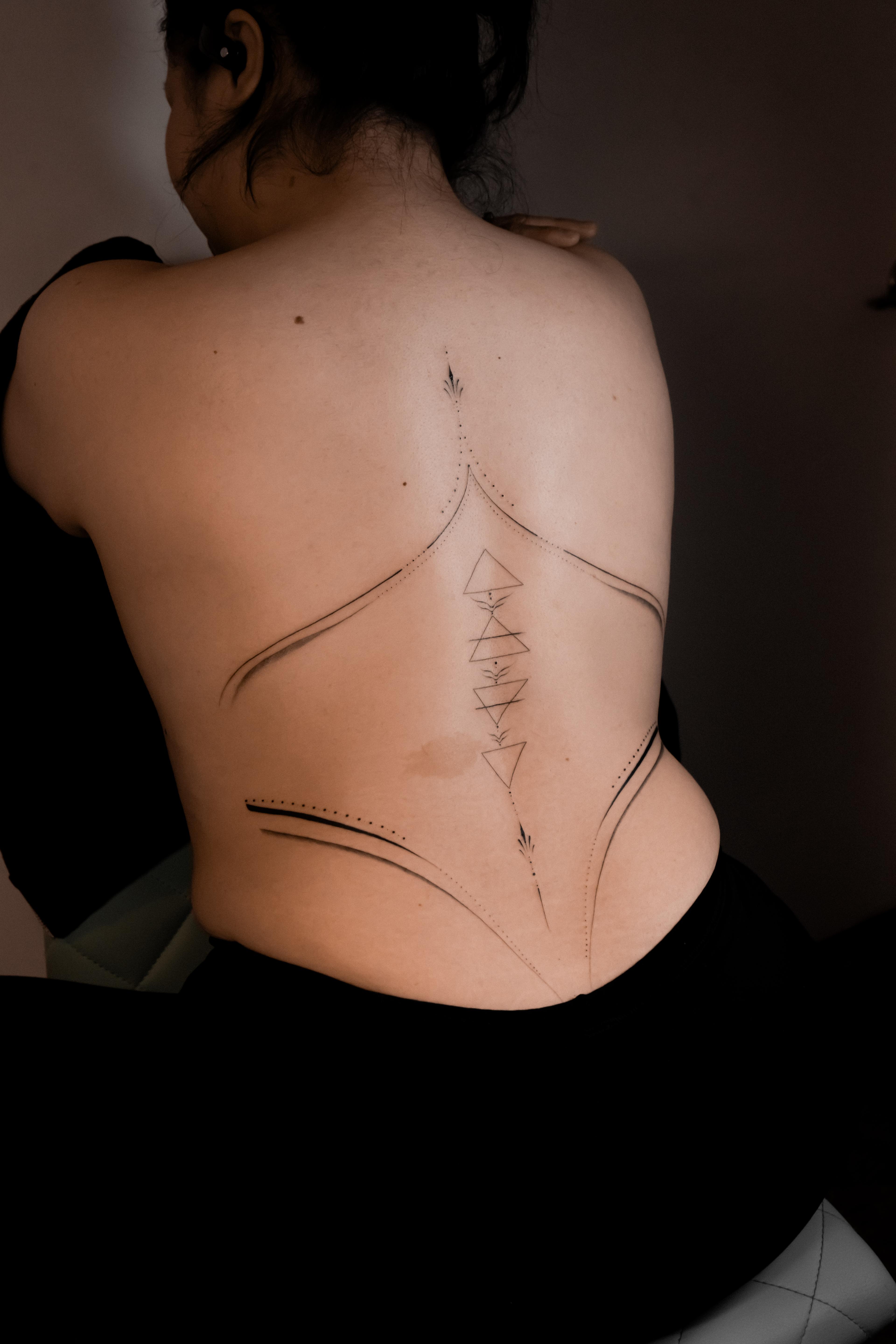 Abstract geometric linework and stacked triangles spanning the full back