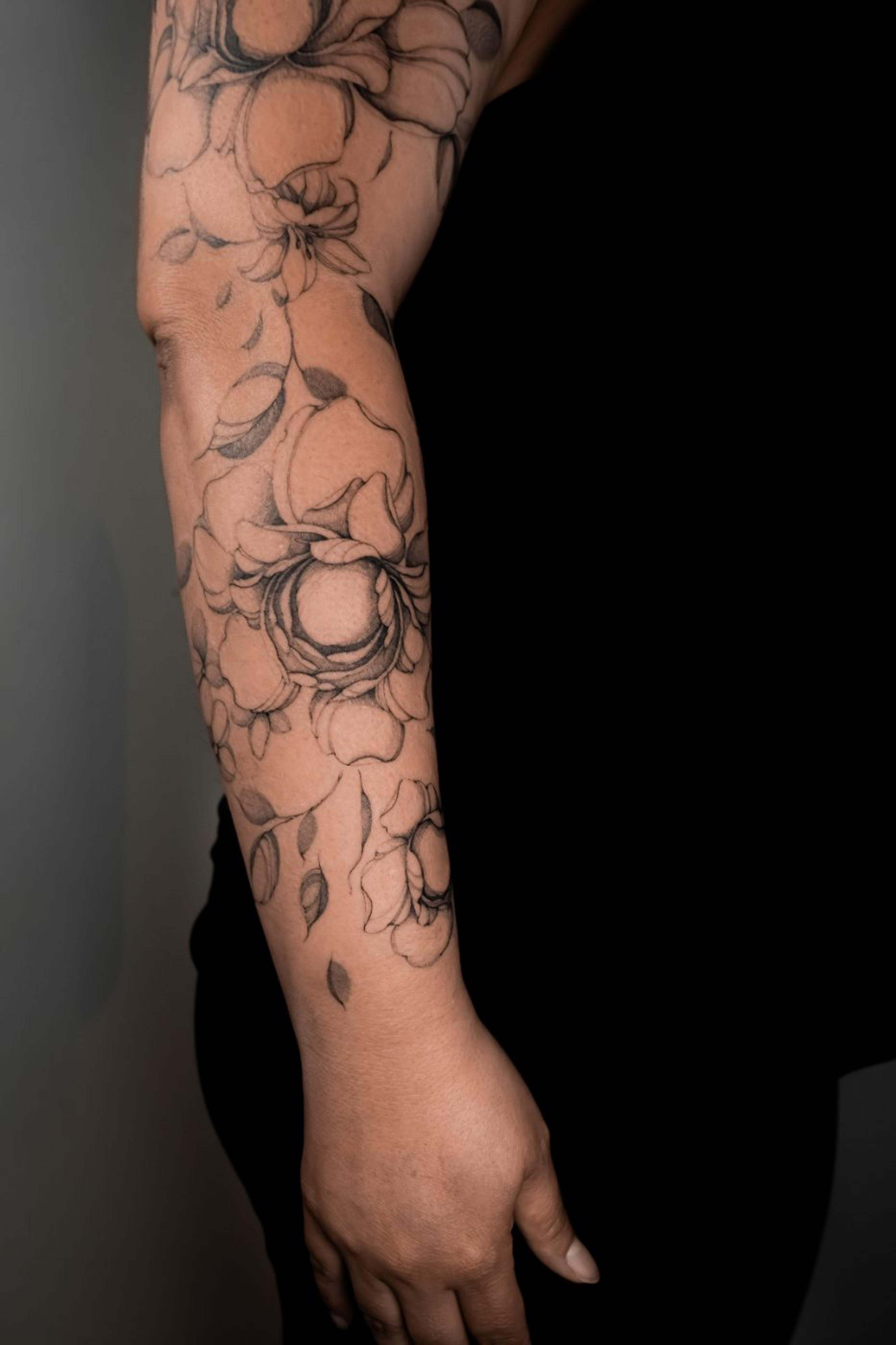 Botanical fine-line sleeve of layered peonies and roses