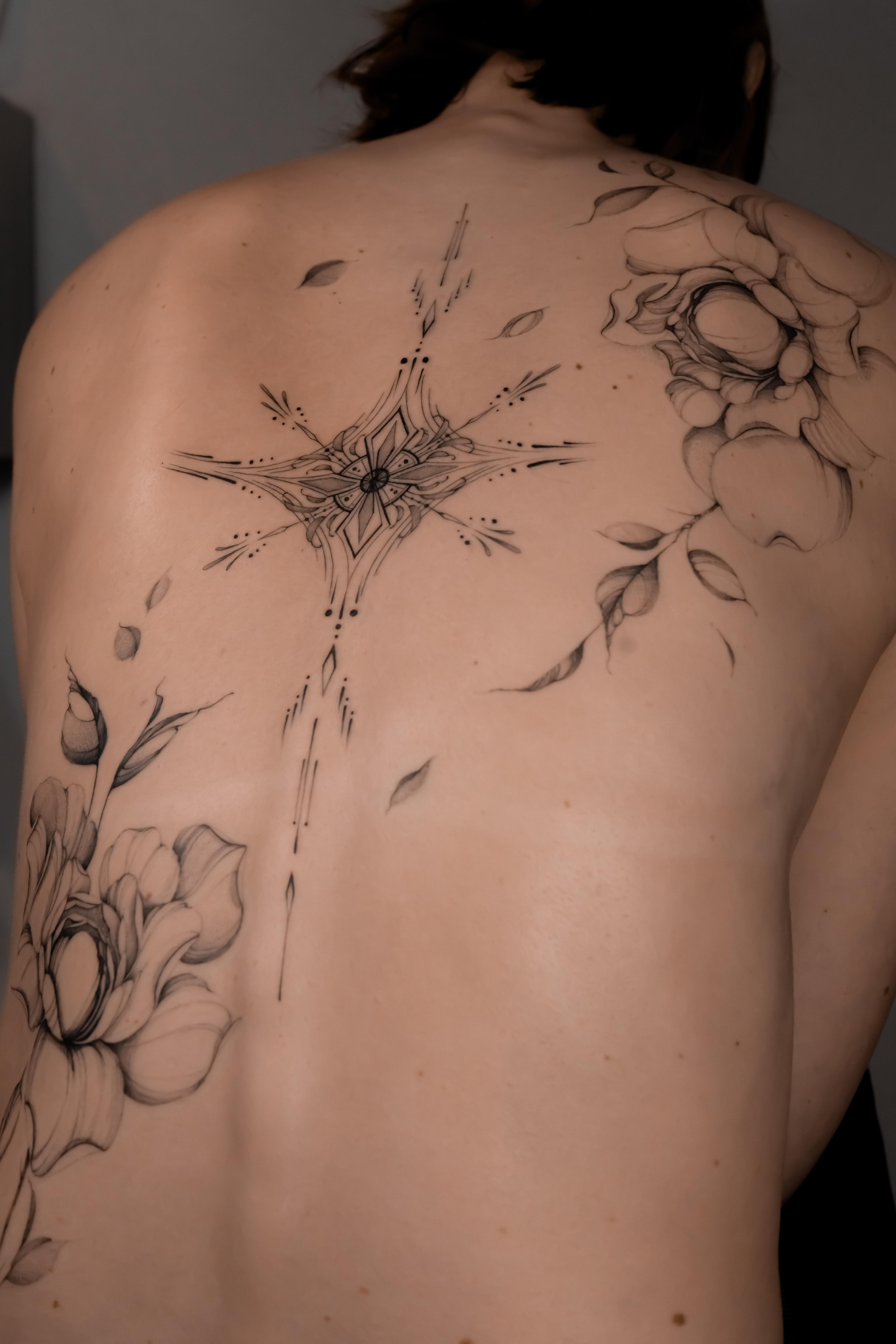 Close view of a central ornament and fine-line peonies across the back