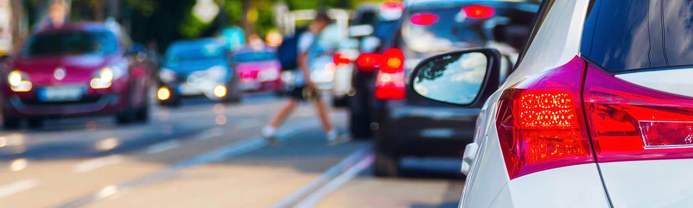 Traffic Waiting For Person To Cross Street