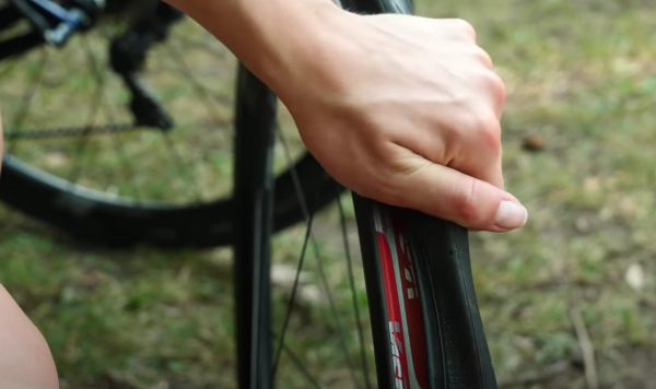 This will create slack, making it easier to remove the tyre from the rim by hand