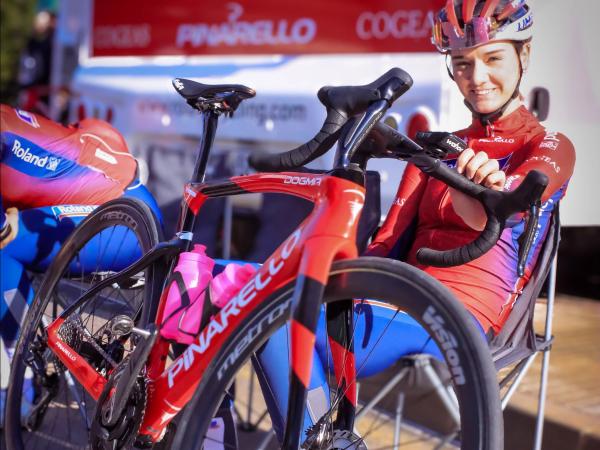 Sylvie Swinkels sits proudly beside one of the team's new Pinarello Dogma F road bikes