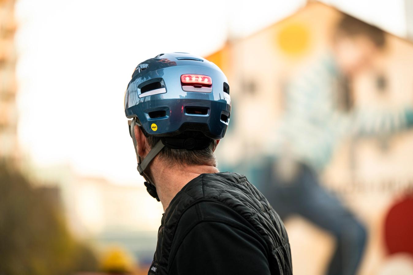The helmet features an integrated USB rechargeable rear light