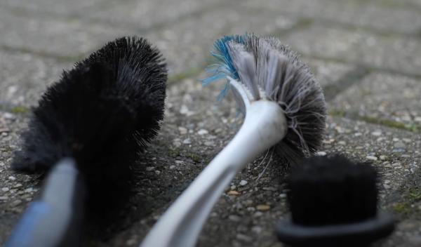Use a firm brush to agitate the dirty chain to help with the cleaning process