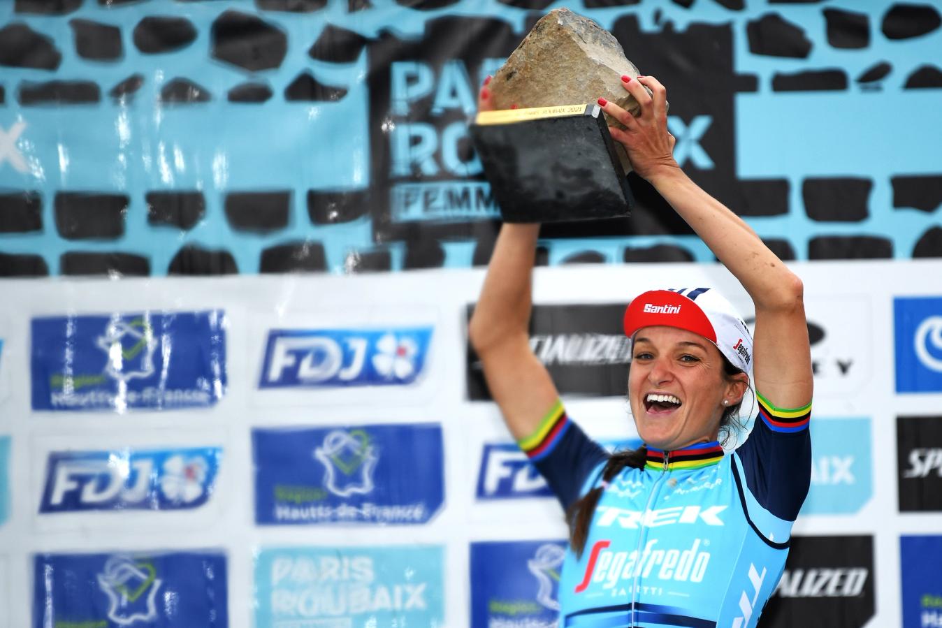 Lizzie Deignan hoists the famous cobblestone trophy aloft after winning the 2021 Paris-Roubaix Femmes