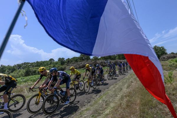 The tricolore shadows the Tour de France peloton, a sign of July