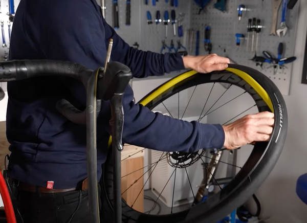 fitting an inner tube into the centre of the rim bed