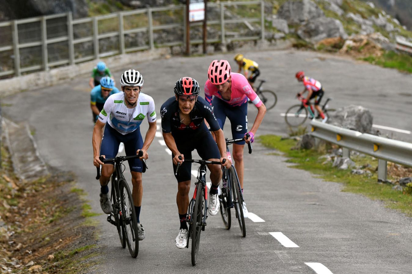 Roglic in red and in trouble at the back as his rivals attack, with Hugh Carthy (in pink) going on to win