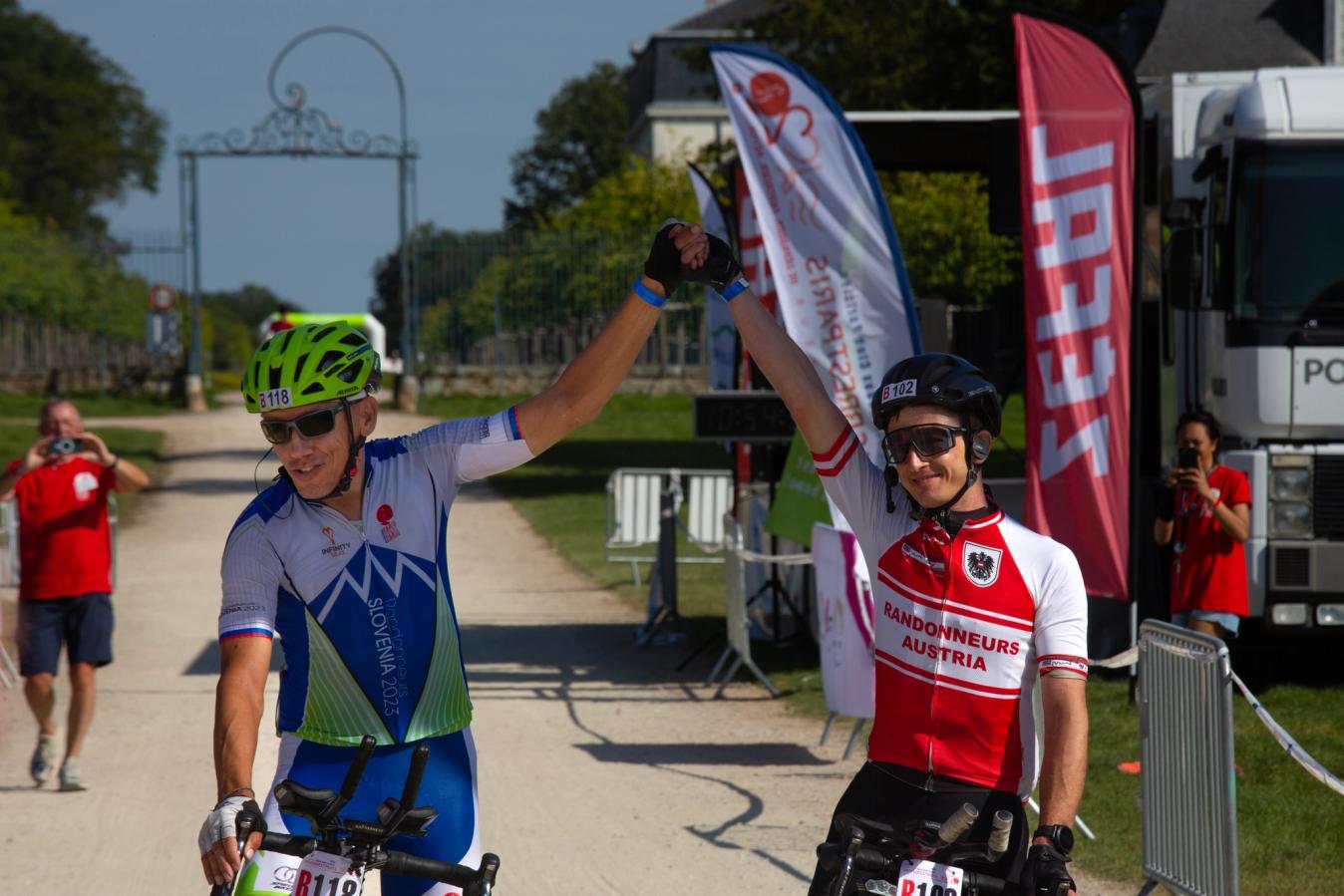 Baloh and Zotter join hands in celebration at the finish in Rambouillet