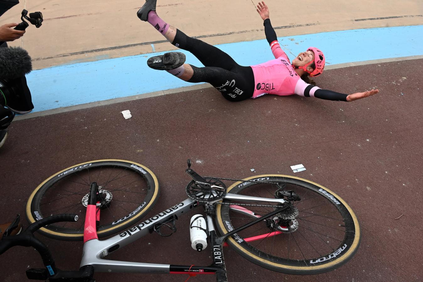 Alison Jackson celebrates alongside her Cannondale bike after winning Paris-Roubaix Femmes