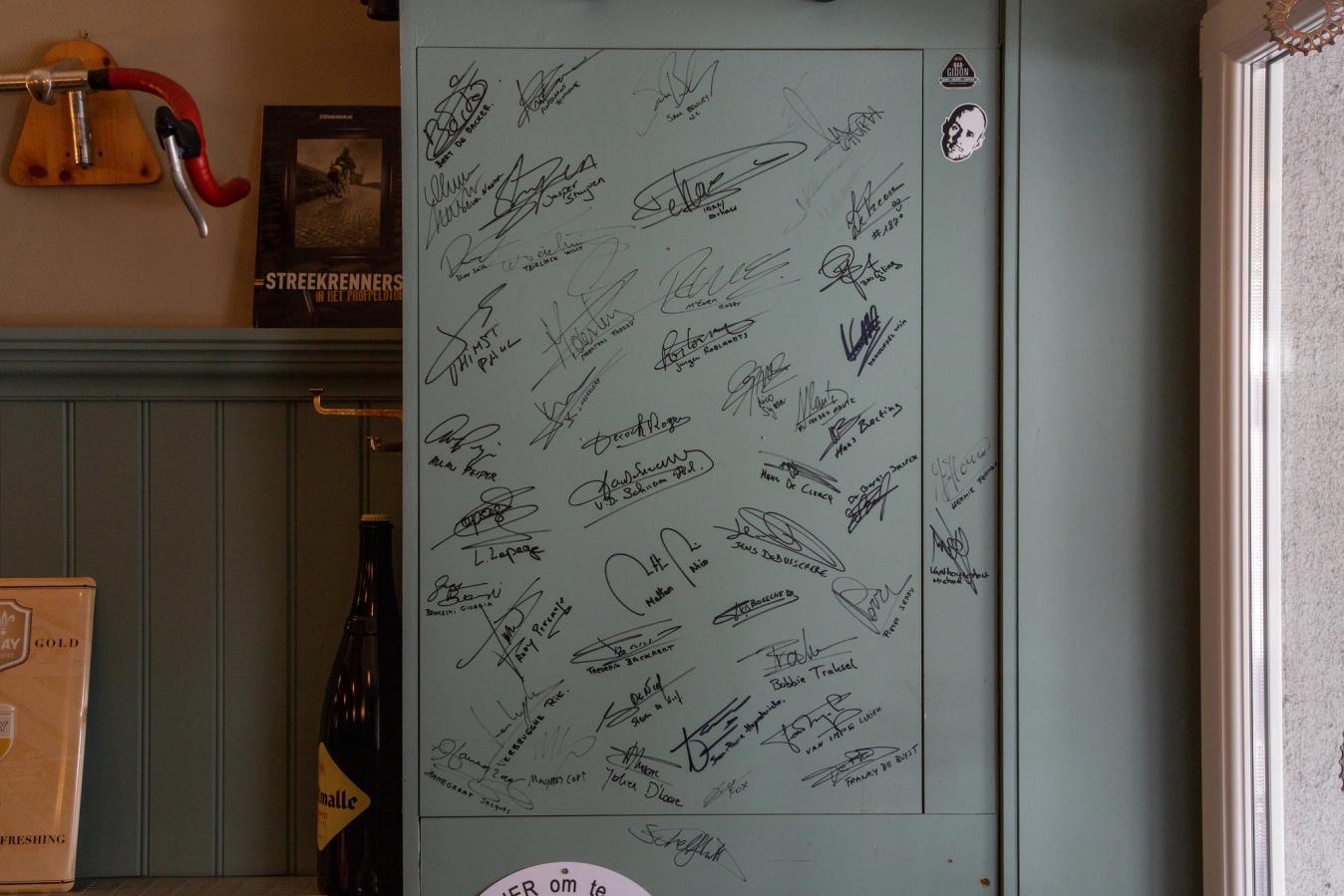 Signatures from pro cyclist visitors cover the walls and tables