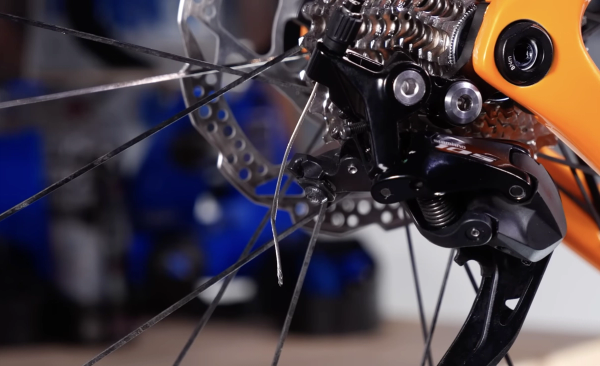 Undo the clamp, pull out the cable, then pull it from the derailleur