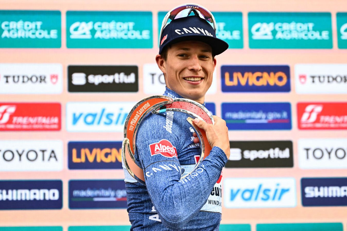 Jasper Philipsen on the top step of the podium at Milan-San Remo