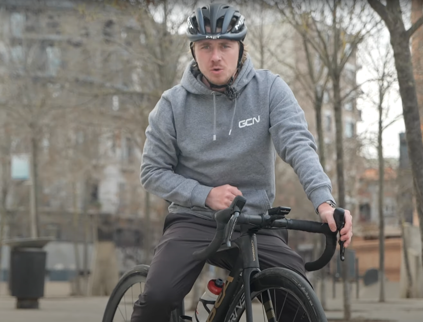 Hank wearing a GCN hoodie on an Orbea bike