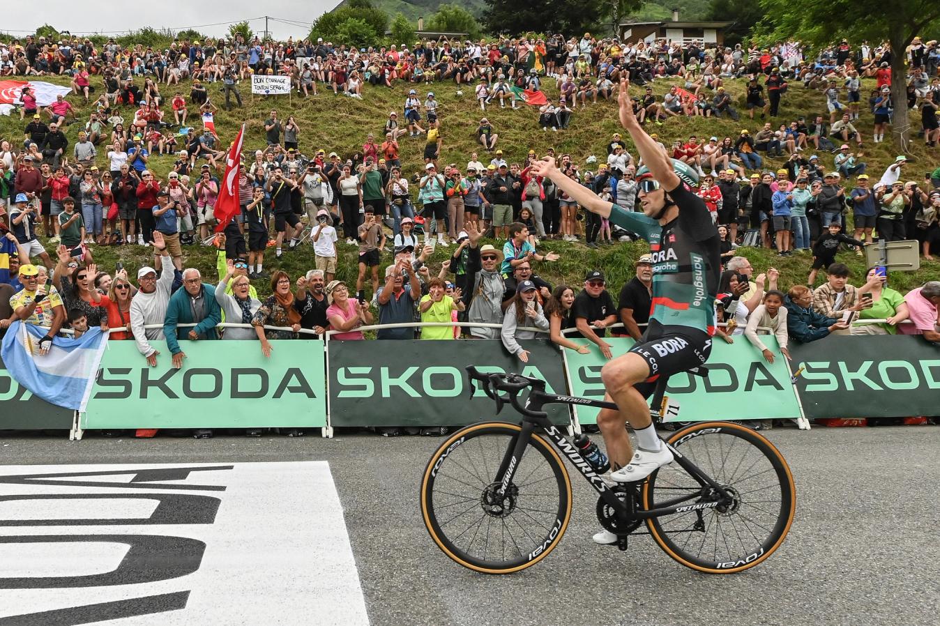  Jai Hindley raises his arms to celebrate his stage 5 victory and accompanying yellow jersey