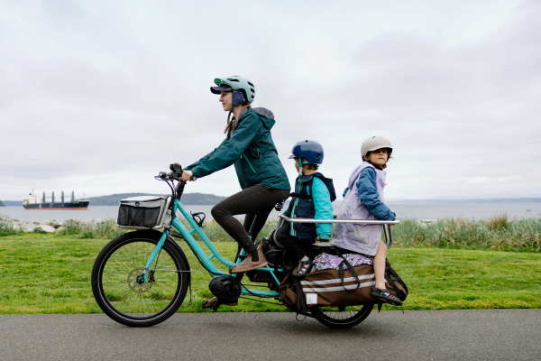 E-cargo bike with rider and two children as passengers