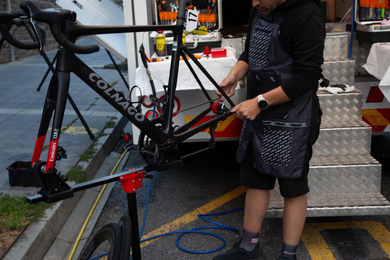 A mechanic prepares one of the team's Colnago V4Rs bikes after stage 3