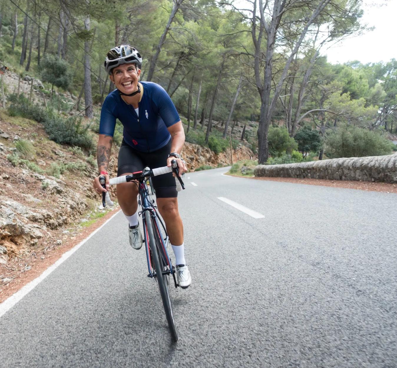 Ottilie Quince cycles uphill in Mallorca