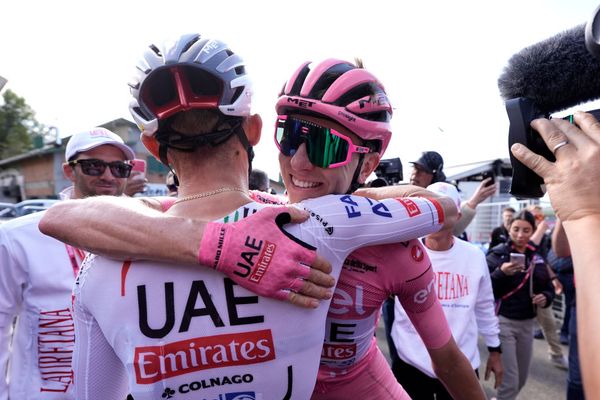 Tadej Pogačar hugs a teammate at the Giro d'Italia