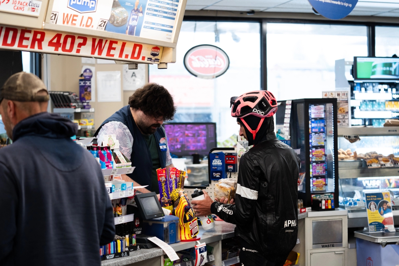 Lachlan Morton grabs some supplies from a convenience store