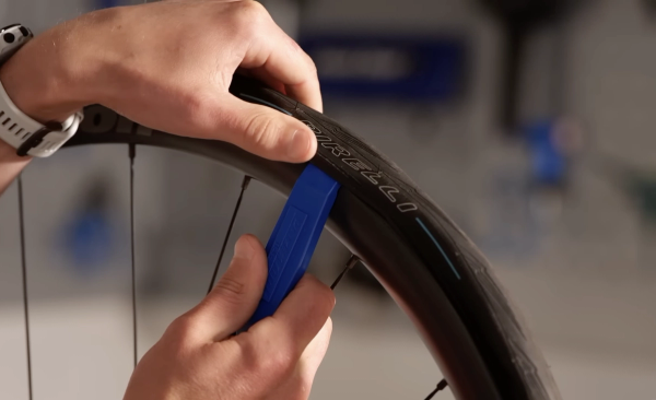 Lever the bead off the rim with a tyre lever